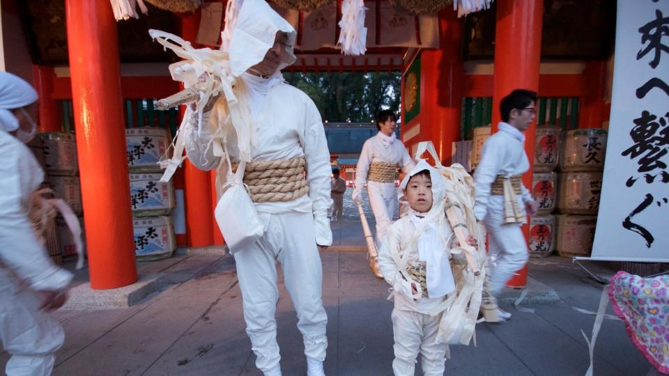 Rituale Angezogen in weißen Gewändern, die für Reinheit stehen und mit Strohseilen um ihre Hüften für heiligen Hchutz tragen Vater und Sohn Fackeln zum Feuerritual in Oto Matsuri in Japan