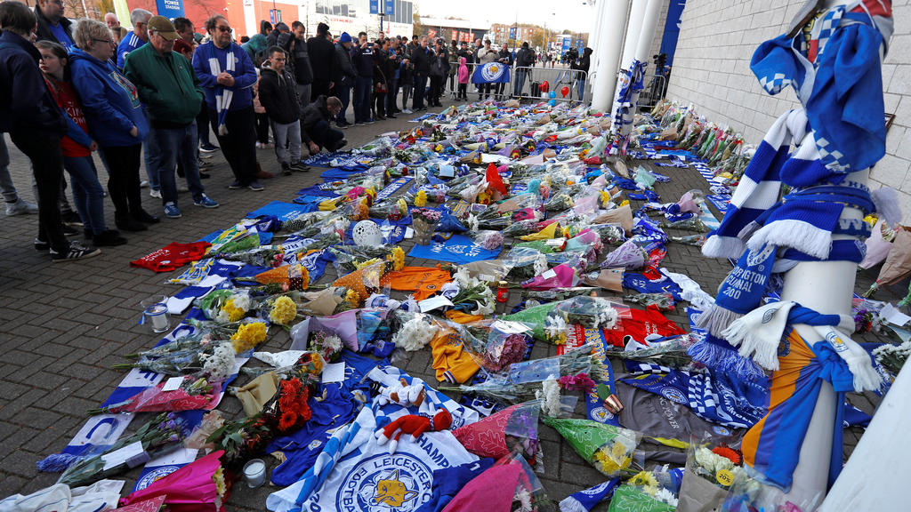 Leicester City football fans pay their respects outside the football stadium, after the helicopter of the club owner Thai businessman Vichai Srivaddhanaprabha crashed when leaving the ground on Saturday evening after the match, in Leicester, Britain,