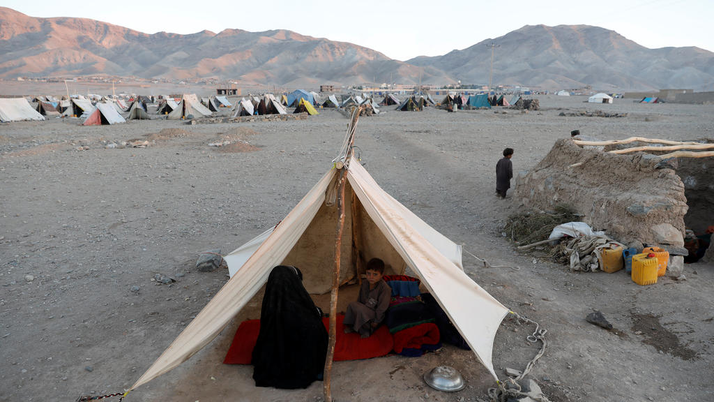 Internally displaced Afghan family sits inside a tent at a refugee camp in Herat province, Afghanistan October 14, 2018. Picture taken October 14, 2018. REUTERS/Mohammad Ismail