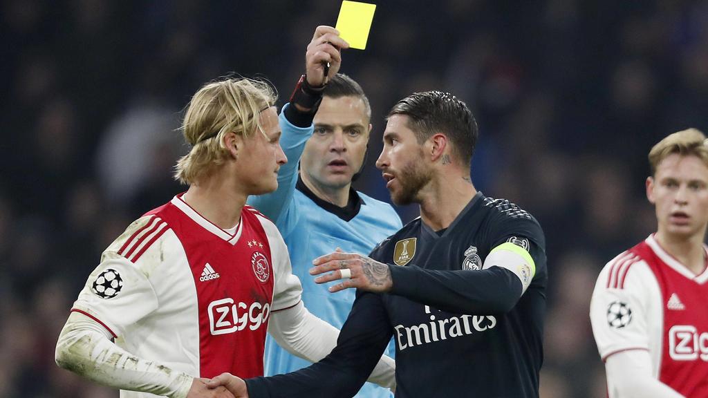 (L-R) Kasper Dolberg of Ajax, referee Damir Skomina, Sergio Ramos of Real Madrid during the UEFA Champions League round of 16 match Ajax Amsterdam and Real Madrid at the Johan Cruijff Arena on February 13, 2019 in Amsterdam, The Netherlands UEFA Cham
