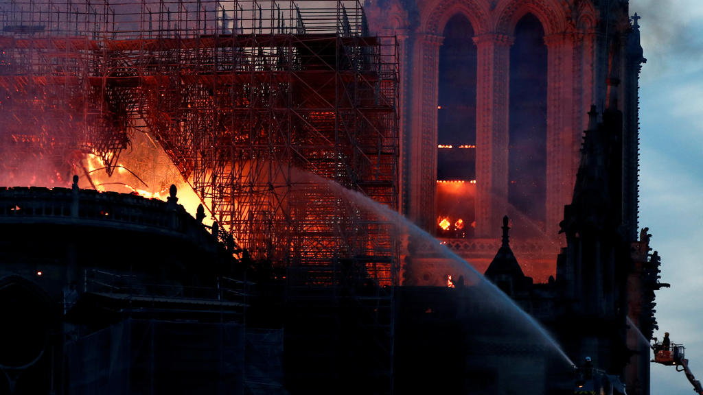 Fire fighters douse flames of the burning Notre Dame Cathedral in Paris, France April 15, 2019. REUTERS/Benoit Tessier