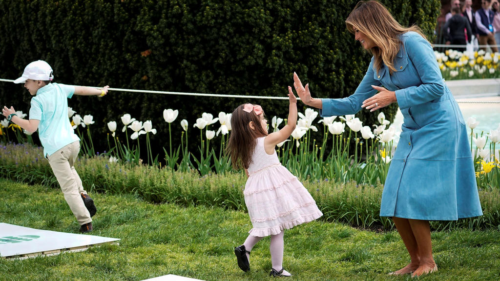 U.S. first lady Melania Trump high fives a child at the hopscotch station during the 2019 White House Easter Egg Roll on the South Lawn of the White House in Washington, U.S., April 22, 2019. REUTERS/Al Drago TPX IMAGES OF THE DAY