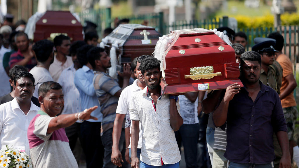 Coffins of victims are carried during a mass for victims, two days after a string of suicide bomb attacks on churches and luxury hotels across the island on Easter Sunday, in Colombo, Sri Lanka April 23, 2019. REUTERS/Dinuka Liyanawatte