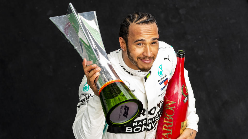SHANGHAI, CHINA - APRIL 14: Race winner Lewis Hamilton of Great Britain and Mercedes GP celebrates on the podium during the F1 Grand Prix of China at Shanghai International Circuit on April 14, 2019 in Shanghai, China. (Photo by Mark Thompson/Getty I