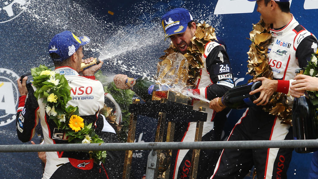 LE MANS, FRANCE - JUNE 16: (L-R) The Toyota Gazoo Racing TS050 Hybrid of Sebastien Buemi, Fernando Alonso and Kazuki Nakajima celebrate winning the Le Mans 24 Hour Race at the Circuit de la Sarthe on June 16, 2019 in Le Mans, France. (Photo by Ker Ro
