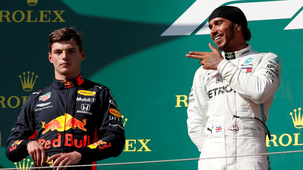 Formula One F1 - Hungarian Grand Prix - Hungaroring, Budapest, Hungary - August 4, 2019 Mercedes' Lewis Hamilton gestures on the podium as he celebrates winning the Hungarian Grand Prix as Red Bull's Max Verstappen looks on REUTERS/Bernadett Szab