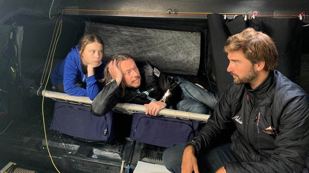Swedish climate activist Greta Thunberg, her father Svante and Skipper Boris Herrmann sit aboard the Team Malizia yacht, that will transport Thunberg across the Atlantic for the UN Climate Action Conference, in Plymouth, Britain August 12, 2019. Pict