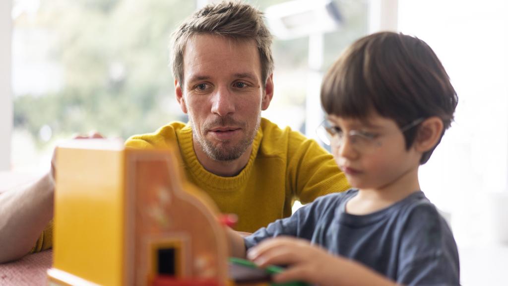 Father and son playing with a toy till model released Symbolfoto property released PUBLICATIONxINxGERxSUIxAUTxHUNxONLY JOSF03086