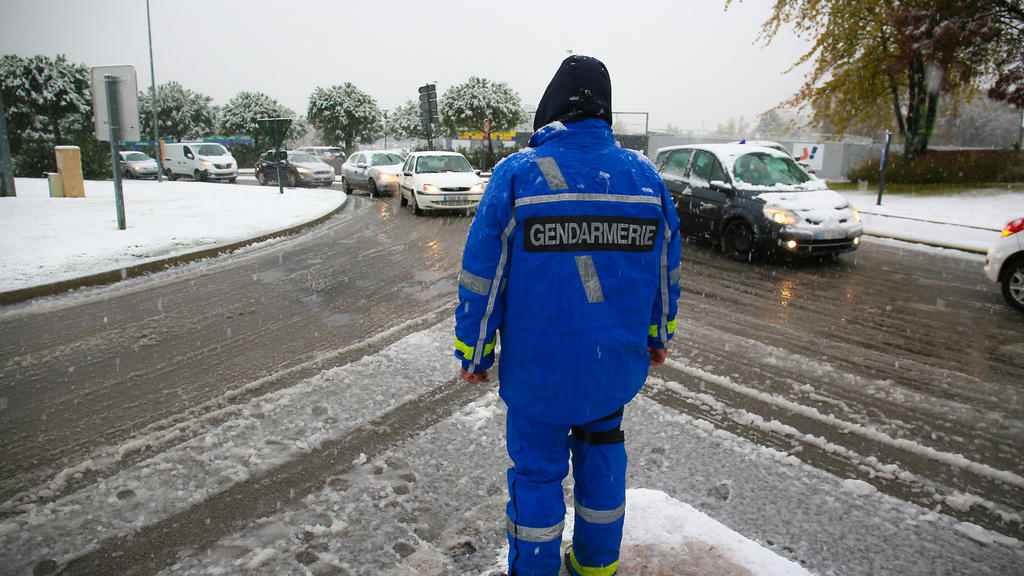FRANCE - WEATHER - SNOW - TRAFFIC - DROME A police officer regulates traffic at the A7 motorway interchange, which is closed to heavy goods vehicles. First snowfall in the Drome which has been placed on orange alert where traffic is disrupted. Valen