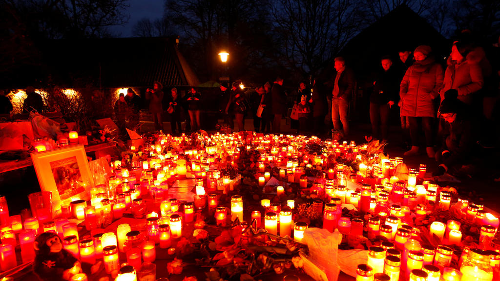 People mourn outside the zoo of Krefeld after a monkey house burned down and dozens of animals were killed by the fire in Krefeld, Germany, January 2, 2020. REUTERS/Thilo Schmuelgen