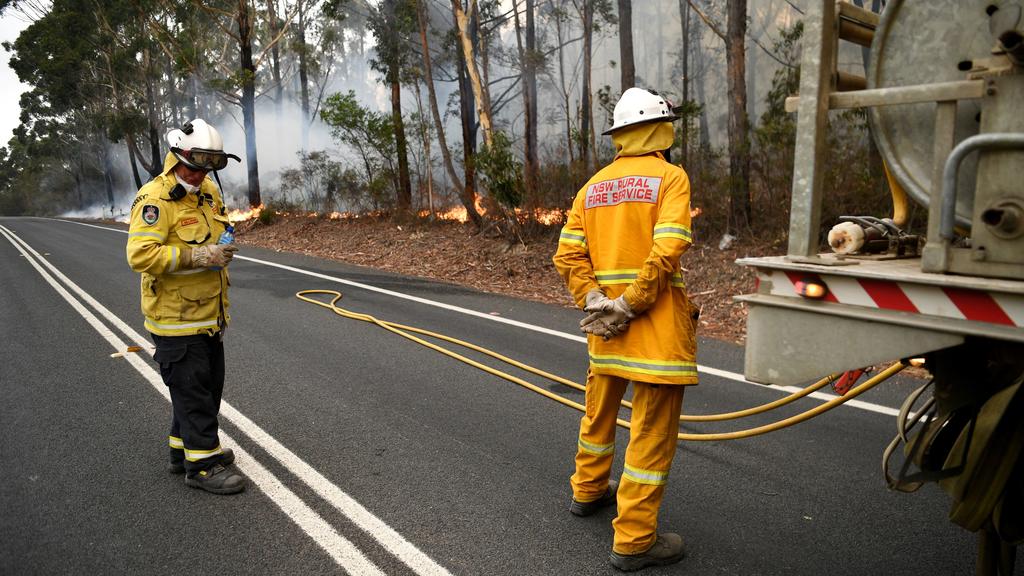Firefighters keep a watchful eye on a fire threatening homes along the Princes Highway near in Milton, Australia January 5, 2020. REUTERS/Tracey Nearmy