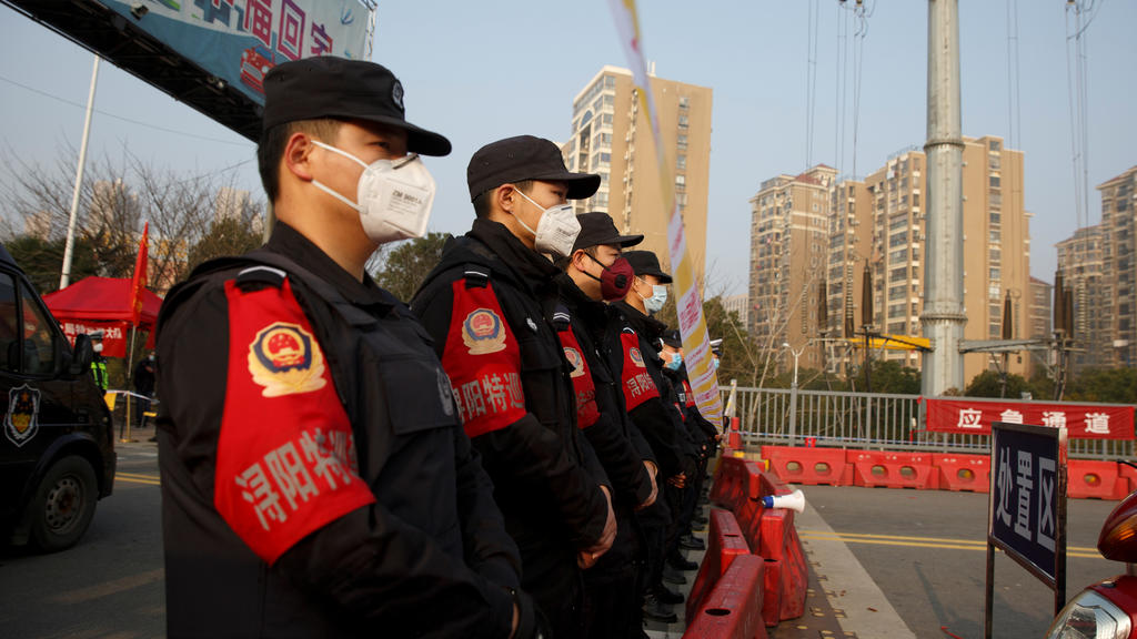 Police stand at a checkpoint at the Jiujiang Yangtze River Bridge that crosses from Hubei province in Jiujiang, Jiangxi province, China, as the country is hit by an outbreak of a new coronavirus, January 31, 2020. Police and security personnel lined