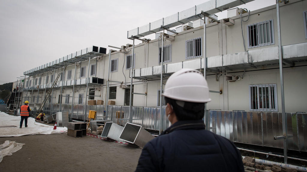 200201 -- WUHAN, Feb. 1, 2020 -- Workers work at the construction site of Huoshenshan Fire God Mountain Hospital in Wuhan, central China s Hubei Province, Feb. 1, 2020. According to the plan, the construction of the hospital will be completed on Feb