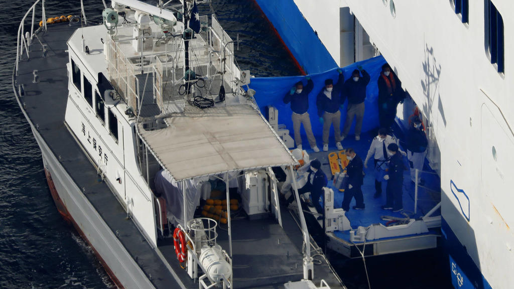 New coronavirus Photo taken from a Kyodo News helicopter on Feb. 5, 2020, shows a Japan Coast Guard patrol boat pulling up beside luxury cruise ship Diamond Princess which has been kept at anchor off Daikoku Pier in Yokohama near Tokyo since Feb. 3 a