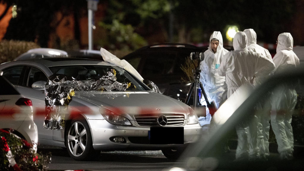Police forensic personnel investigate at the scene after a shooting in central Hanau, Germany Thursday, Feb. 20, 2020. A German man shot and killed several people at different locations in a Frankfurt suburb overnight. (AP Photo/Michael Probst)