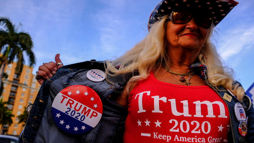 Kathy Clark wears merchandise supporting U.S. President Donald Trump outside the convention center where Democratic U.S. presidential candidate Michael Bloomberg is holding his Super Tuesday night rally, in West Palm Beach, Florida, U.S., March 3, 20
