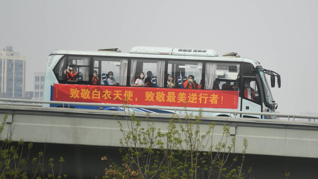 200323 -- WUHAN, March 23, 2020 -- Medics from Guangdong Province take a bus to the airport in Wuhan, central China s Hubei Province, March 23, 2020. A total of 322 members of a medical assistance team from Guangdong Province left Wuhan of Hubei Pro