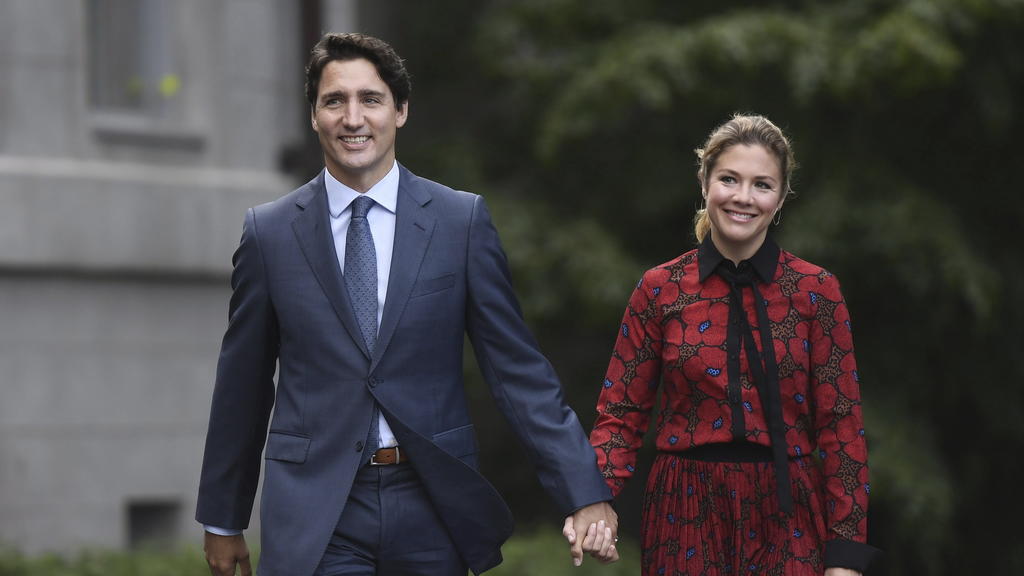 In this Wednesday, Sept. 11, 2019 photo, Canada's Prime Minister Justin Trudeau and his wife Sophie Gregoire Trudeau arrive at Rideau Hall in Ottawa, Ontario. Trudeau is quarantining himself at home after his wife exhibited flu-like symptoms. Trudeau
