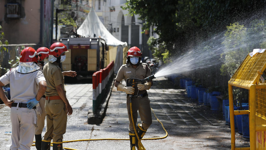 Delhi fire officers disinfect an area at Nizamuddin, from where several people who attended an Islamic congregation earlier this month were tested positive for Covid-19, in New Delhi, India, Thursday, April 2, 2020. Police in New Delhi have filed a c