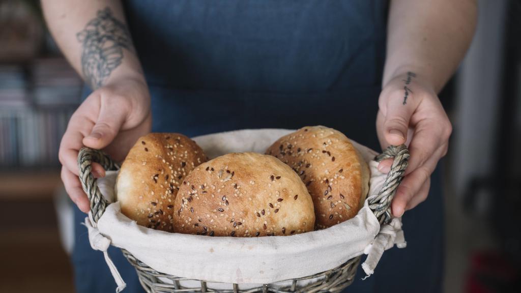 Woman holding basket with homemade vegan bread rolls model released Symbolfoto property released PUBLICATIONxINxGERxSUIxAUTxHUNxONLY ALBF00400