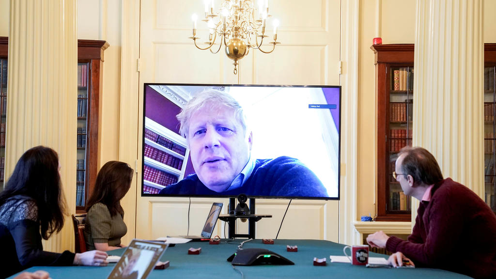 FILE PHOTO: Britain's Prime Minister Boris Johnson appears on a monitor for the coronavirus disease (COVID-19) meeting in London, Britain March 28, 2020. The prime minister chairs the morning update meeting on the coronavirus remotely from Number 11