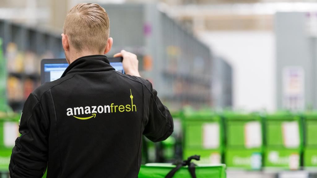 ARCHIV - 18.07.2017, Berlin: Ein Mitarbeiter des Lebensmittellieferdienstes Amazon Fresh steht Depot der Firma. Jahrelang zeigten die Verbraucher in Deutschland den Angeboten von Online-Lebensmittelhändlern die kalte Schulter und kauften Fleisch und