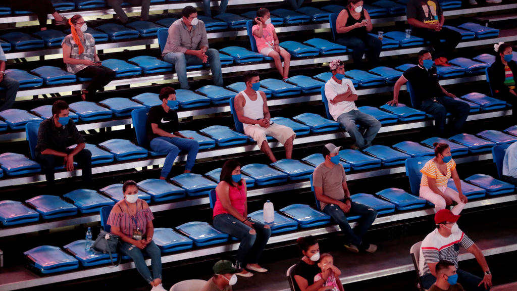 Boxing - Bufalo Boxing - Polideportivo Alexis Arguello, Managua, Nicaragua - April 25, 2020 Fans wearing protective face masks are seated with social distancing, despite most sport being cancelled around the world as the spread of the coronavirus d
