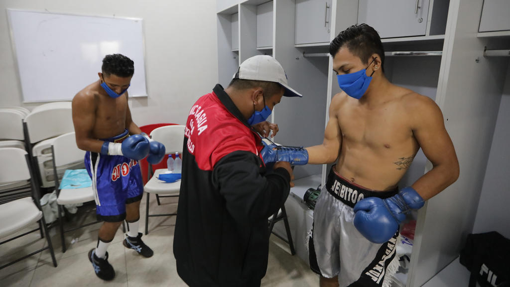 MANAGUA, NICARAGUA - APRIL 25: Nicaraguan Boxers wearing face masks get ready in the locker rooms at Alexis Arguello Sports Center on April 25, 2020 in Managua, Nicaragua. Nicaragua is one of the very few countries that allow sport events during the