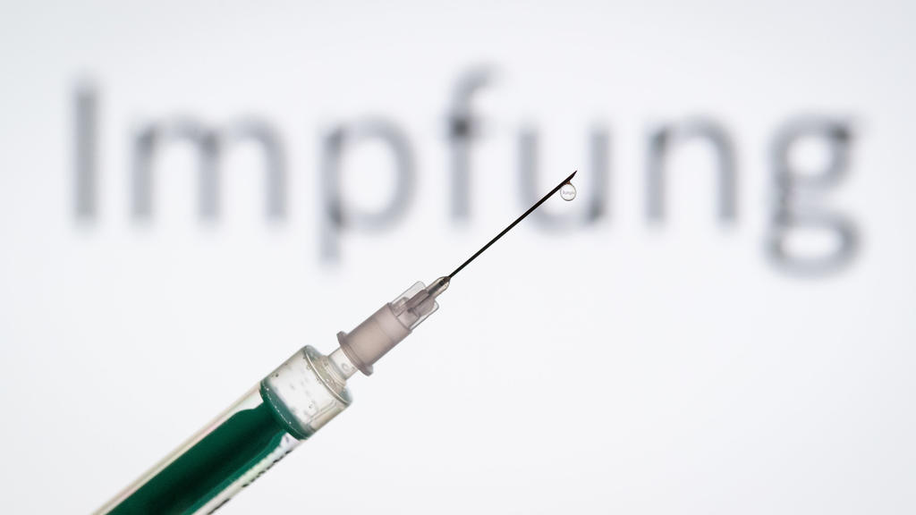 FILE - 05/11/2019, North Rhine-Westphalia, Bielefeld: ILLUSTRATION - A syringe is held in front of the letters 