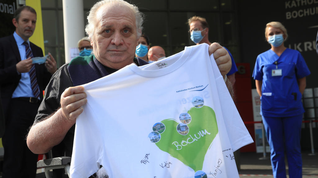 Claudio Facoetti, a 65-year-old man from the northern Italian city of Bergamo, near Milan, holds a T-shirt signed by the intensive care nurses of the Saint Josef university clinic after he recovered within six weeks from the coronavirus disease (COVI