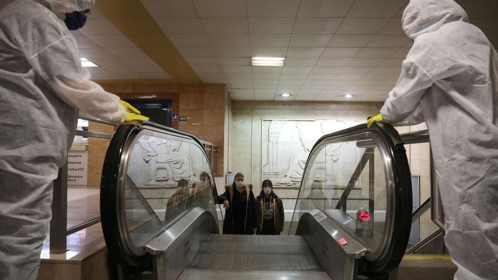 FILE PHOTO: Workers disinfect an escalator in Serdika metro station, following the outbreak of the coronavirus disease (COVID-19), Sofia, Bulgaria, April 8, 2020. REUTERS/Stoyan Nenov/File Photo