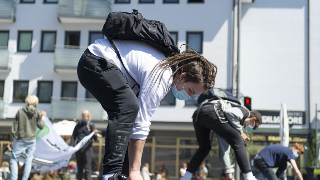 15.05.2020, Hessen, Frankfurt/Main: Einen Slogan sprühen Teilnehmer der Fridays for Future Demonstration auf den Asphalt. Es ist die erste reguläre Versammlung der Klimaaktivisten in Frankfurt nach drei Monaten. Foto: Sebastian Kramer/dpa +++ dpa-Bil