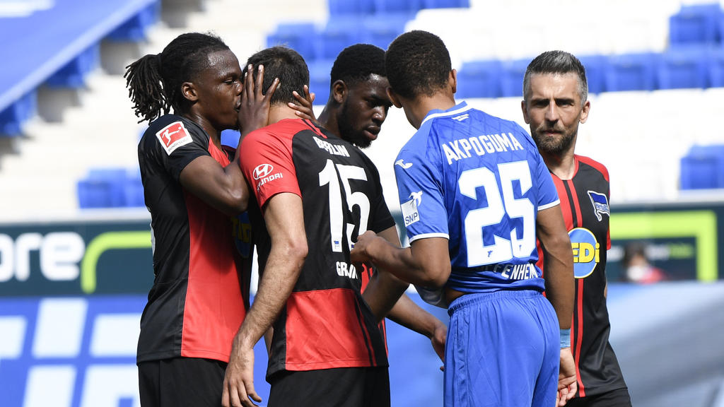 Hertha's Belgian defender Dedryck Boyata, left, talks to teammate Serbian midfielder Marko Grujic during the Bundesliga soccer match between TSG 1899 Hoffenheim and Hertha BSC Berlin in Sinsheim, Germany, Saturday, May 16, 2020. The German Bundesliga
