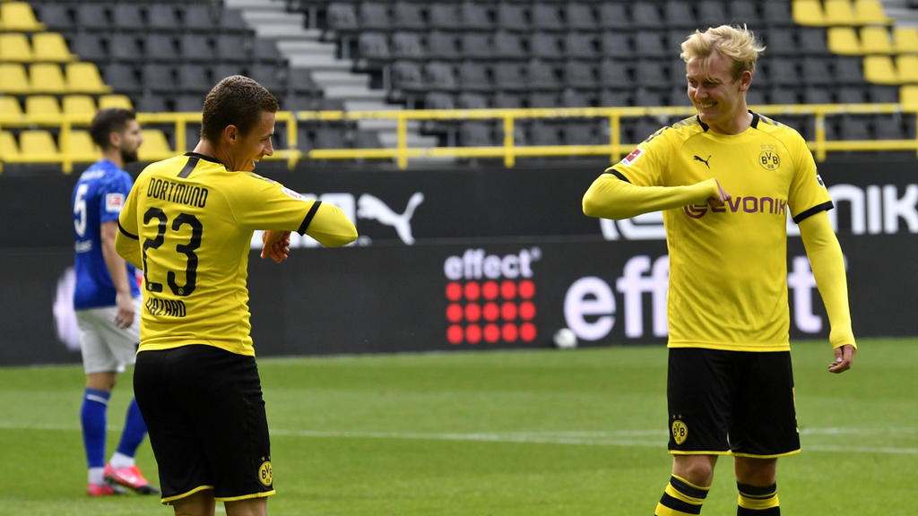 Dortmund's Thorgan Hazard, left, celebrates with Erling Haaland after scoring his side's third goal during the German Bundesliga soccer match between Borussia Dortmund and Schalke 04 in Dortmund, Germany, Saturday, May 16, 2020. The German Bundesliga
