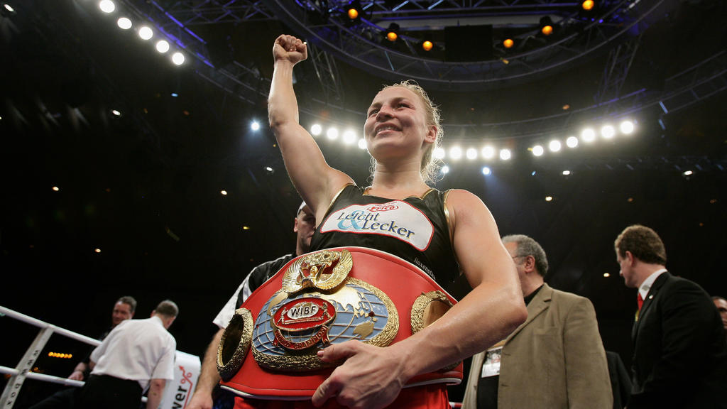 KARLSRUHE, GERMANY - NOVEMBER 30: Regina Halmich of Germany celebrates after beating Hagar Shmoulefeld Finer of Israel in defense of her WIBF World Championship flyweight title at the DM Arena on November 30, 2007 in Karlsruhe, Germany. Halmich has