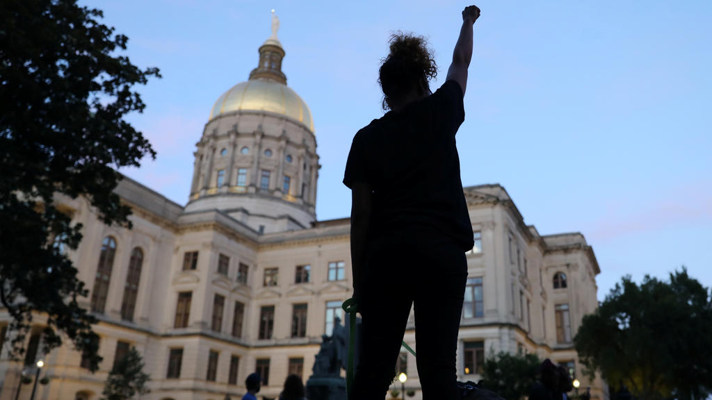 A demonstrator holds up a fist during a protest against racial inequality and the police shooting death of Rayshard Brooks, in Atlanta, Georgia, U.S June 17, 2020.REUTERS/Goran Tomasevic