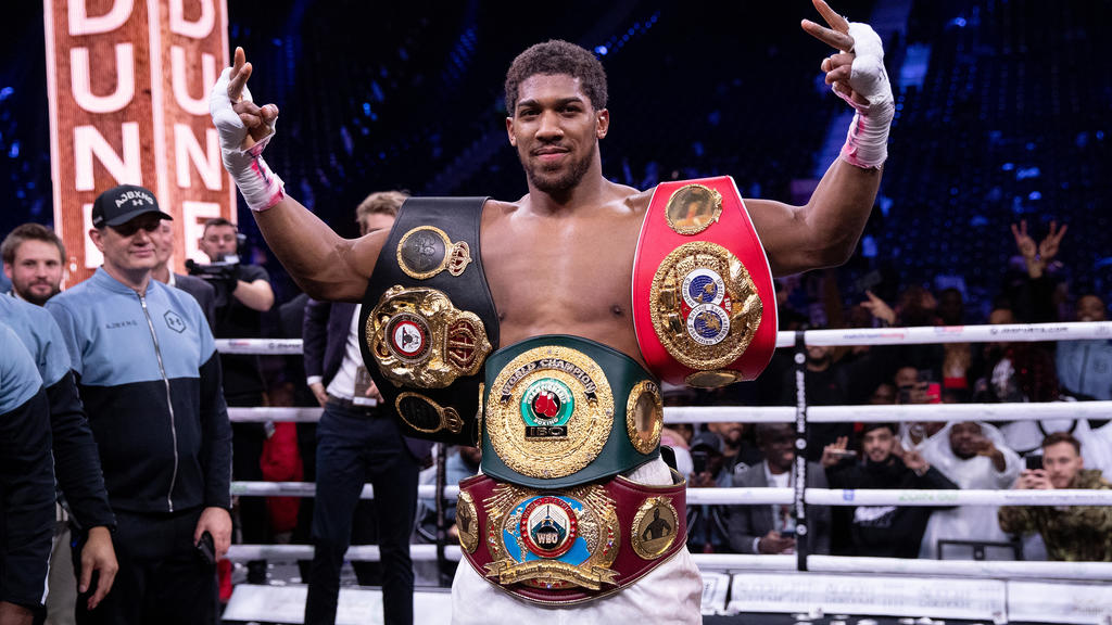 DIRIYAH, SAUDI ARABIA - DECEMBER 07: Anthony Joshua poses for a photo with the IBF, WBA, WBO & IBO World Heavyweight Title belts after the IBF, WBA, WBO & IBO World Heavyweight Title Fight between Andy Ruiz Jr and Anthony Joshua during the Matchroom