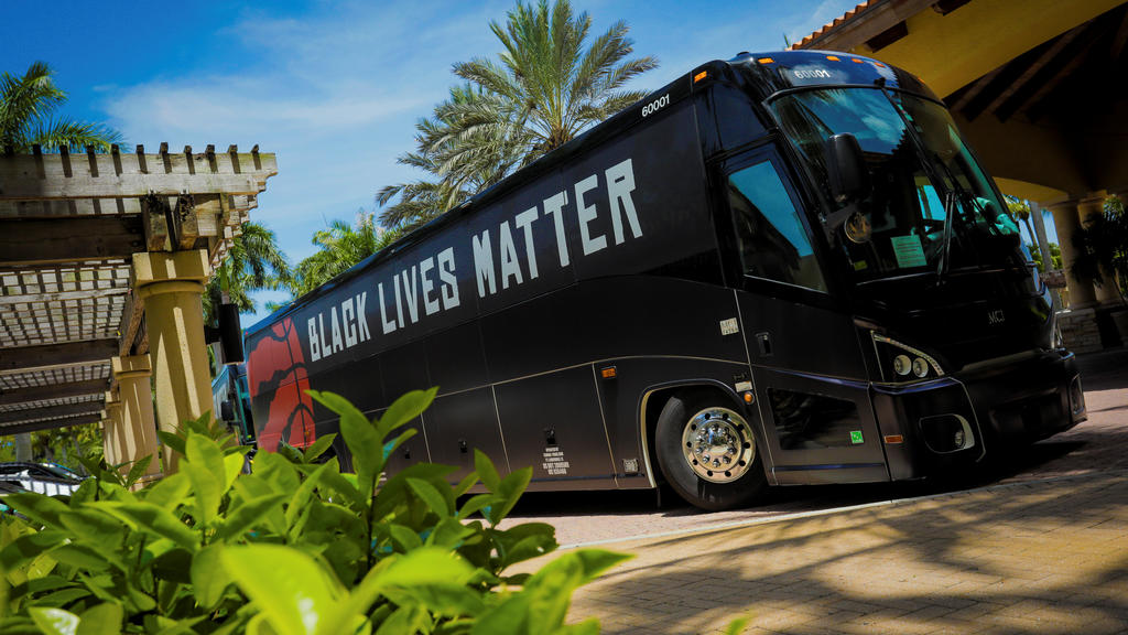 A team bus carrying the NBA champions Toronto Raptors basketball team, with Black Lives Matter displayed on the sides, arrives at the Walt Disney World complex outside Orlando, Florida, U.S. July 9, 2020. Toronto Raptors/Handout via REUTERS. NO RESA