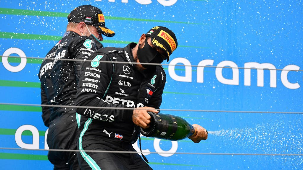 Formula One F1 - Hungarian Grand Prix - Hungaroring, Budapest, Hungary - July 19, 2020 Mercedes' Lewis Hamilton celebrates winning the race on the podium with third placed Mercedes' Valtteri Bottas Joe Klamar/Pool via REUTERS