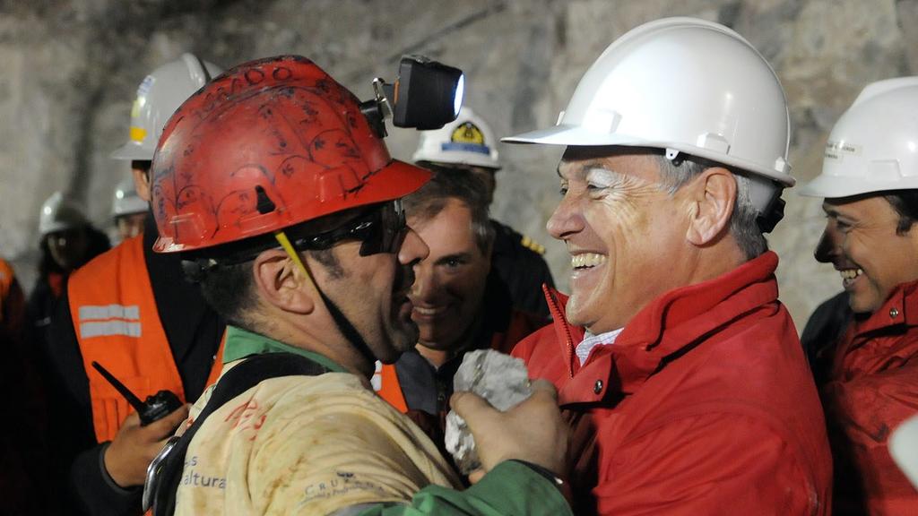 A handout picture released by the Chilean Presidential Office, shows Chilean President Sebastian Pinera (R) as he greets miner Mario Sepulveda after Sepulveda was rescued from the collapsed San Jose gold and copper mine near Copiapo, Chile, 13 Octobe