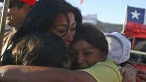 A picture dated 22 August 2010 shows Chilean relatives waiting outside a collapsed mine where about 33 miners are trapped in Copiapo, Chile. Relatives celebrated the arrival of a probe to where the trapped miners are supposed to be. Photo: Hector Ret