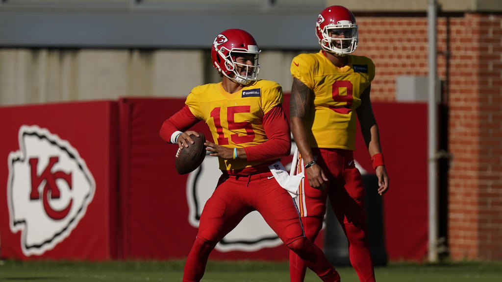 Kansas City Chiefs quarterback Patrick Mahomes throws while quarterback Jordan Ta'amu (9) watches during an NFL football training camp practice Thursday, Aug. 27, 2020, in Kansas City, Mo. (AP Photo/Charlie Riedel)