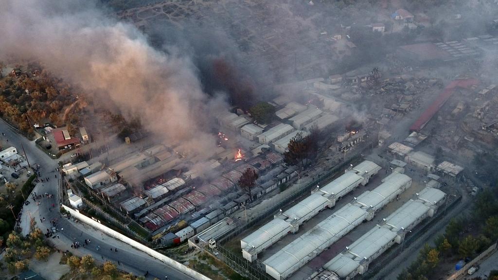 Fire burns container houses and tents in the Moria refugee camp on the northeastern Aegean island of Lesbos, Greece, on Wednesday, Sept. 9, 2020. A fire swept through Greece's largest refugee camp that had been placed under COVID-19 lockdown, leaving