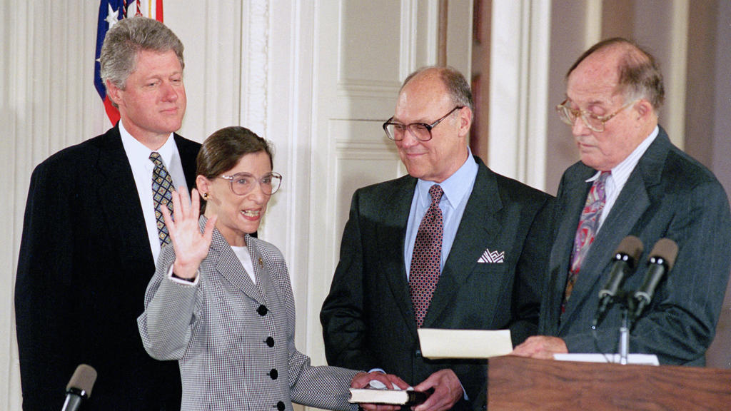 FILE - In this Aug. 10, 1993, file photo, Supreme Court Justice Ruth Bader Ginsburg takes the court oath from Chief Justice William Rehnquist, right, during a ceremony in the East Room of the White House in Washington. Ginsburg's husband Martin holds