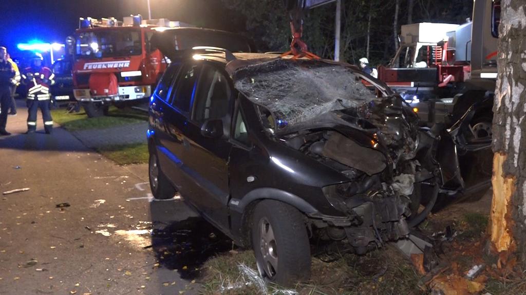 26.09.2020, Niedersachsen, Saterland: Einsatzkräfte der Feuerwehr und der Polizei stehen an einem Unfallort. Bei dem schweren Verkehrsunfall im Landkreis Cloppenburg ist eine Mutter gestorben und sechs Kinder schweben in Lebensgefahr. Zudem wurde ein