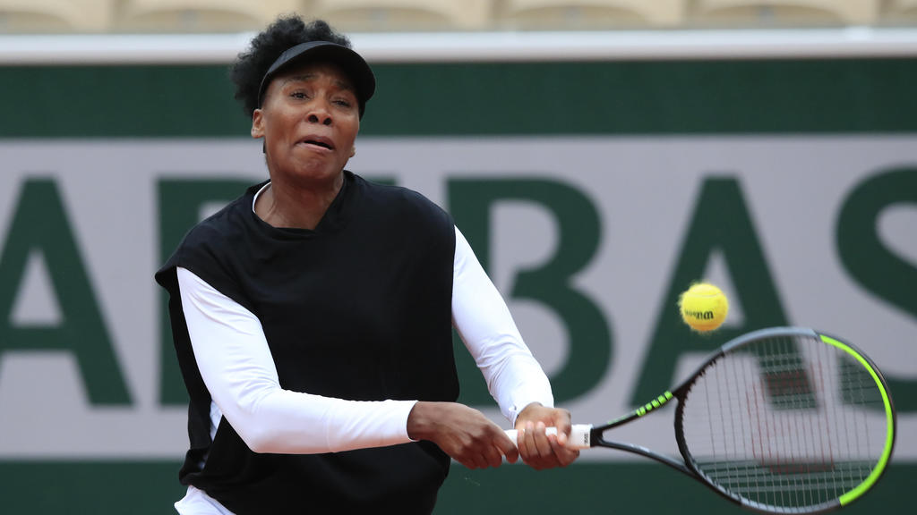 Venus Williams of the U.S. plays a shot against Slovakia's Anna Karolina Schmiedlova in the first round match of the French Open tennis tournament at the Roland Garros stadium in Paris, France, Sunday, Sept. 27, 2020. (AP Photo/Michel Euler)