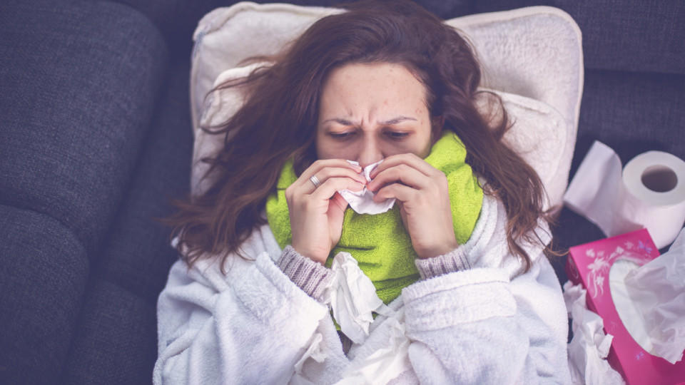 Woman suffering from influenza sleeping in bed