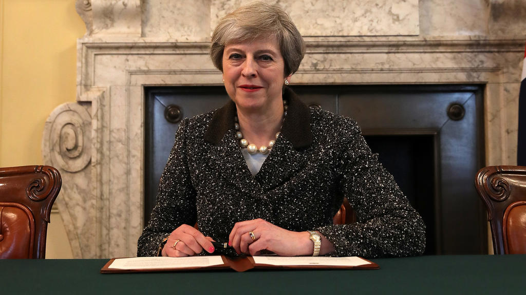British Prime Minister Theresa May in the cabinet office signs the official letter to European Council President Donald Tusk invoking Article 50 and the United Kingdom's intention to leave the EU on March 28, 2017 in London, England. After holding a