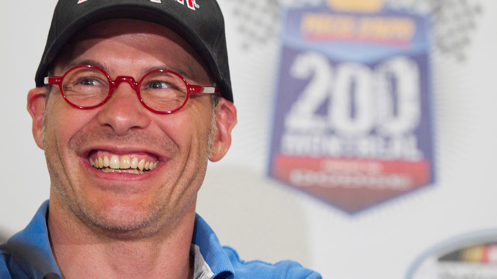 FILE PHOTO: Canadian race car driver Jacques Villeneuve smiles as he speaks to the media prior to the NAPA Auto Parts 200 Nationwide Series NASCAR race in Montreal, August 18, 2011. REUTERS/Christinne Muschi/File Photo
