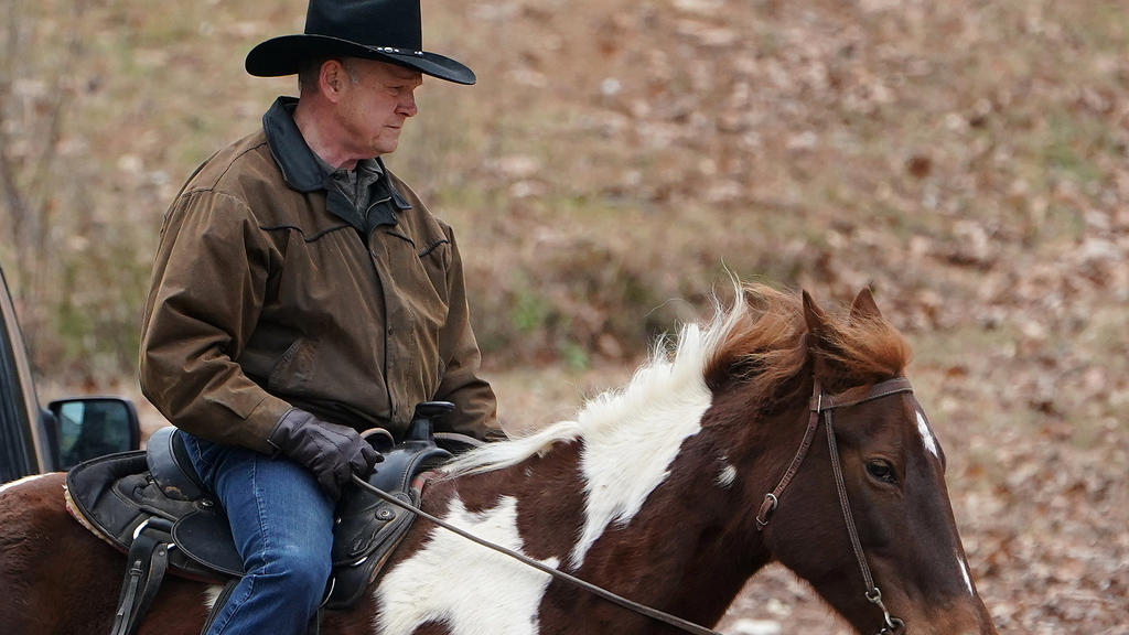 Republican Senate candidate Roy Moore arrives on his horse to cast his ballot in Gallant, Alabama, U.S., December 12, 2017. REUTERS/Carlo Allegri